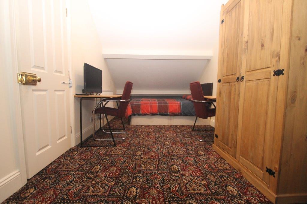 Sixth student bedroom with double bed, two door wardrobe and two desks