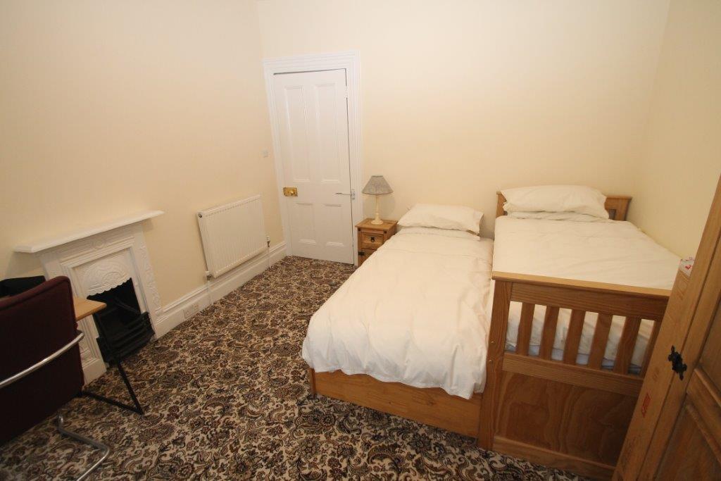 Fourth student bedroom with single bed turn to two, bedside table, two door wardrobe and desk