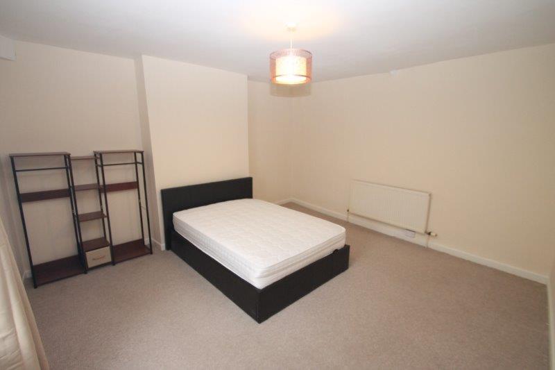 large second student bedroom with double bed and clothing rail