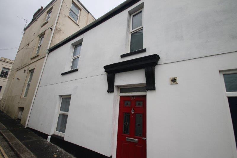 Exterior of the property, white building with red front door