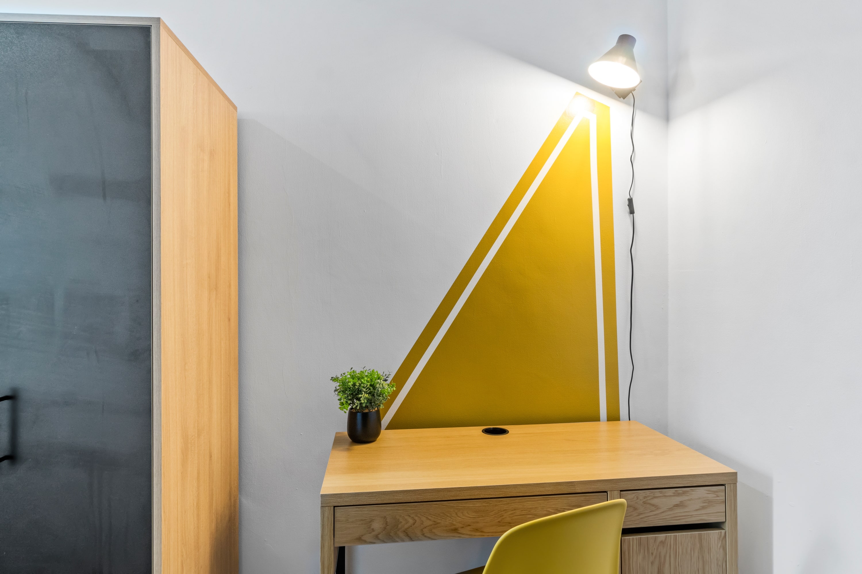 close up of desk with yellow chair