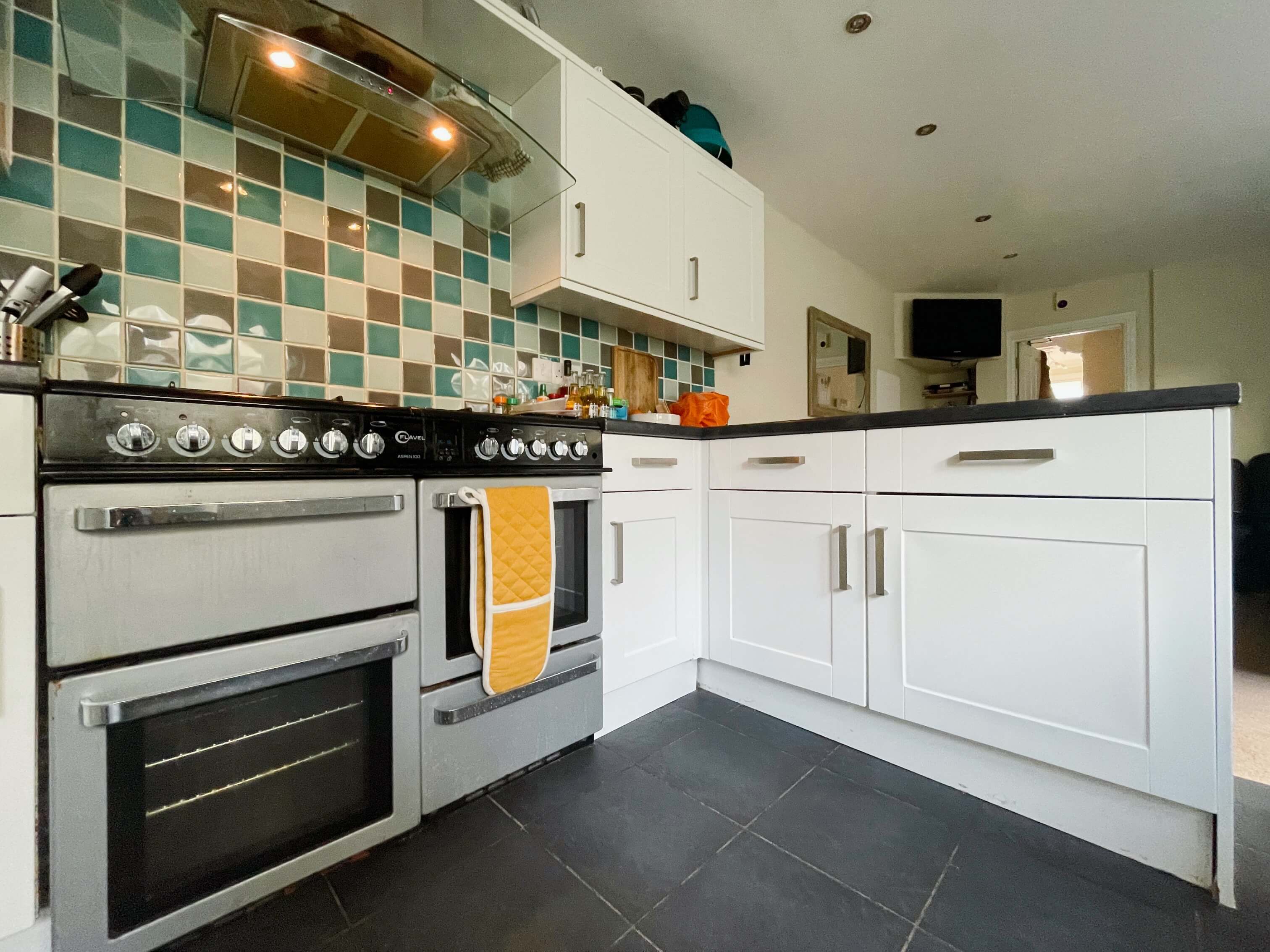 Shared kitchen with two cookers, gas hobs leading into shared living space