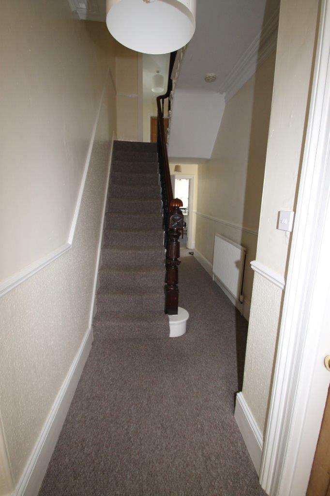 hallway on property, staircase going to first floor