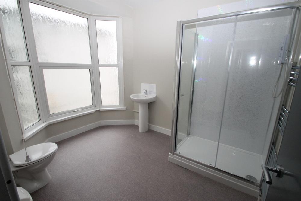 large bathroom with shower and large glazed bay windows