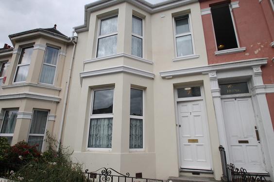 Front of the property, off white building