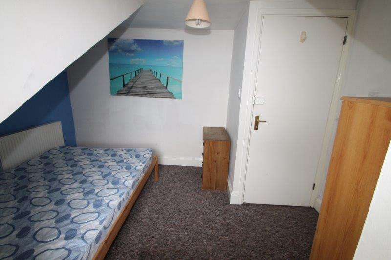 student bedroom with double bed and two chest of drawers, 