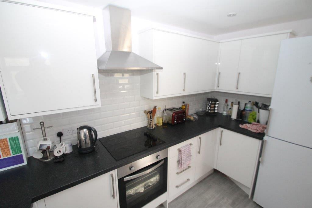 Kitchen with fridge freezer, induction hobs and cooker