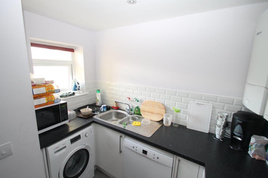 Kitchen with washer/dryer, dishwasher, sink and microwave