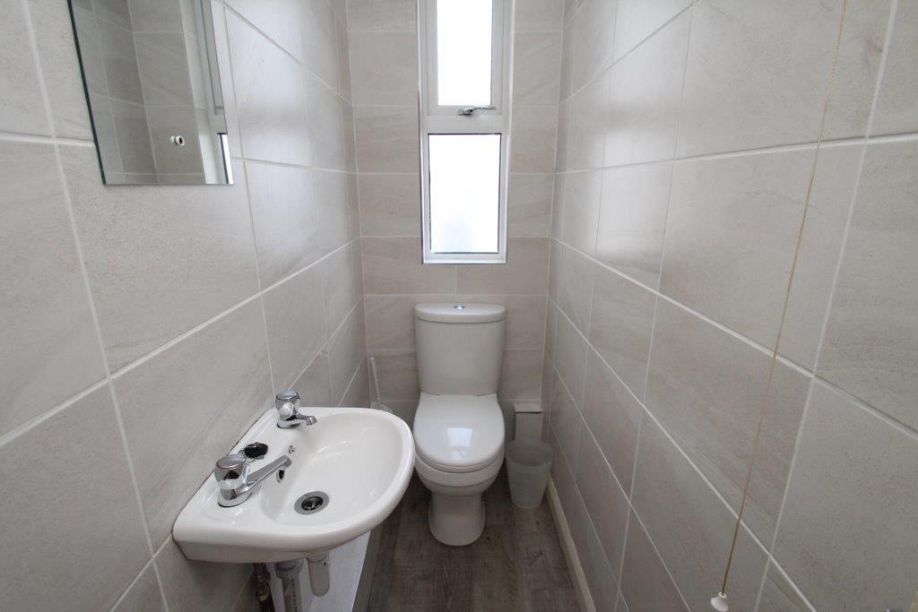 Separate WC with sink and mirror above sink