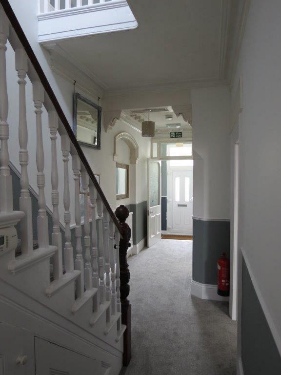hallway to the front of the property and stairs going to first floor