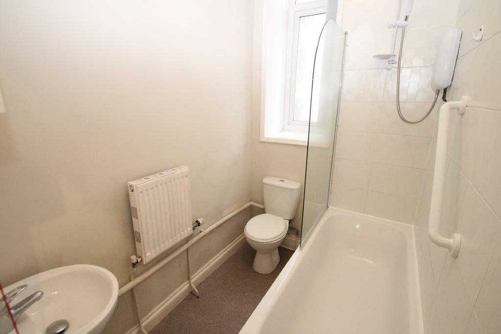 Shared bathroom with bath with shower head