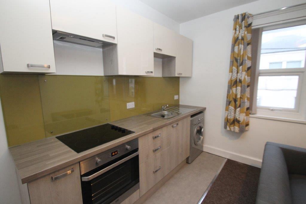 Kitchen with induction hobs and cooker, washer/dryer and sink