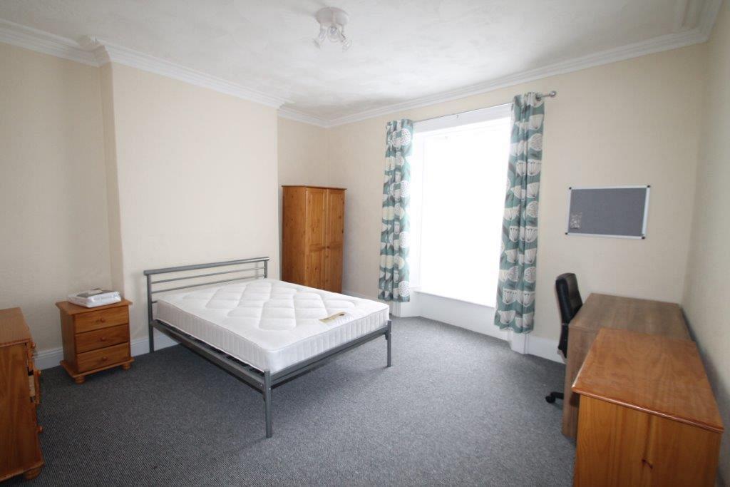 Fifth student bedroom with double bed, two chest of drawers, bedside table, two door wardrobe and desk with office chair