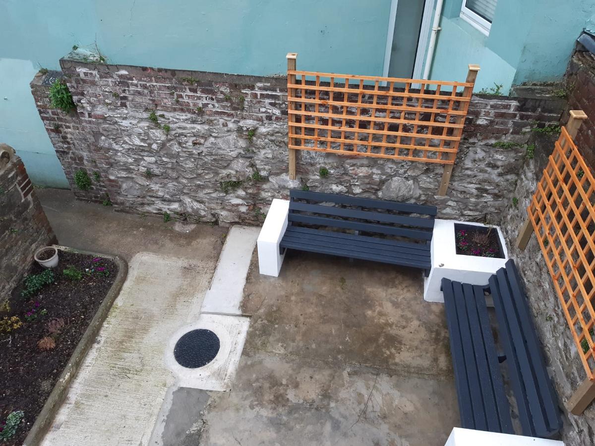 birds eyes view of the back patio with two benches