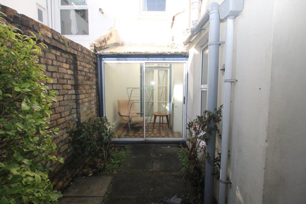 Back patio facing towards the property showing the large patio doors to the foyer