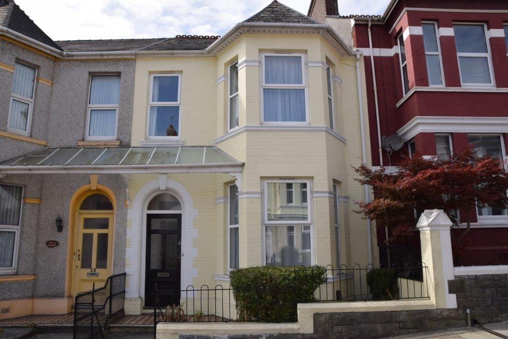 Front of the property, yellow building