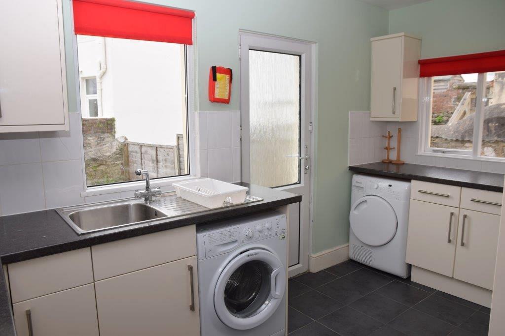 Shared kitchen with washing machine and tumble dryer, back door for exit into back garden