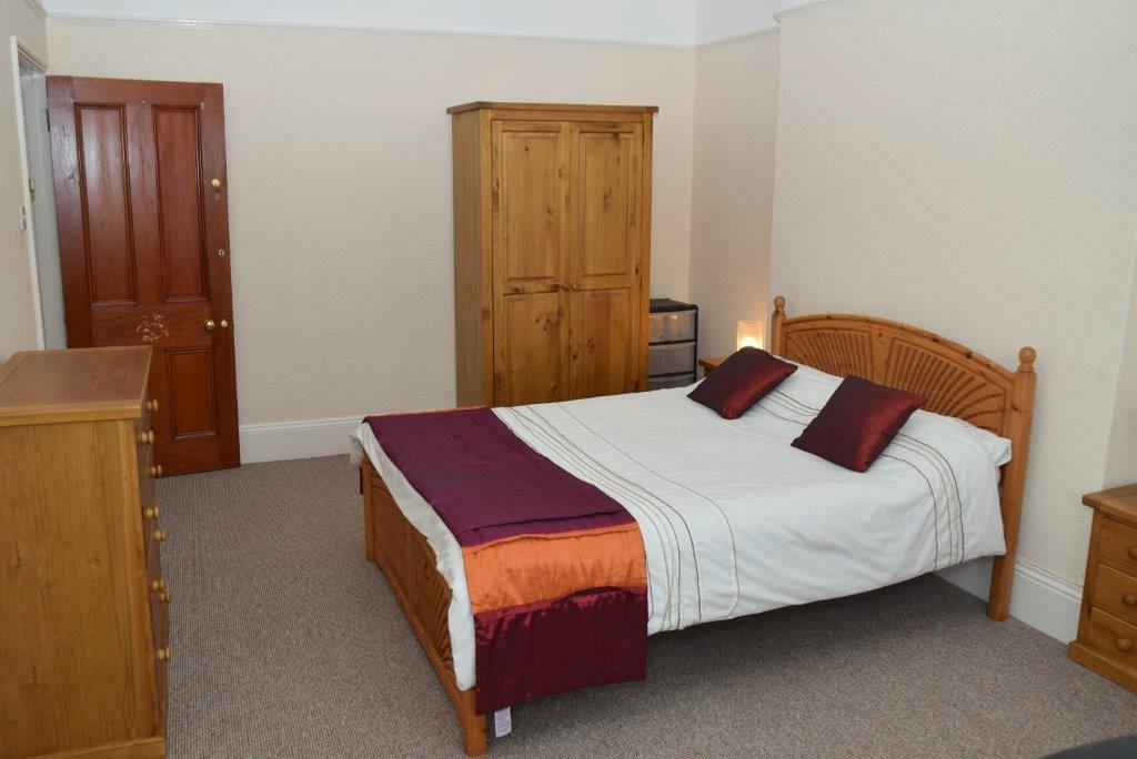 Fifth student bedroom with double bed, two door wardrobe, chest of drawers and bedside table