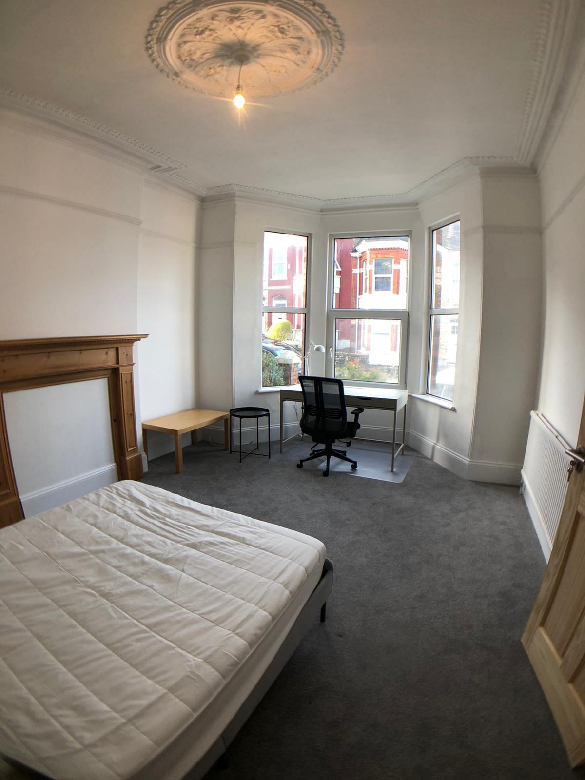 Second student bedroom with double bed and desk
