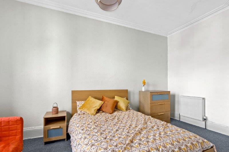 Student bedroom with double bed, bedside table, chest of drawers and two door wardrobe
