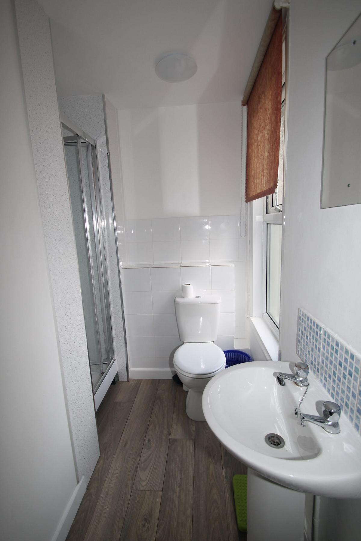 White shared bathroom with shower