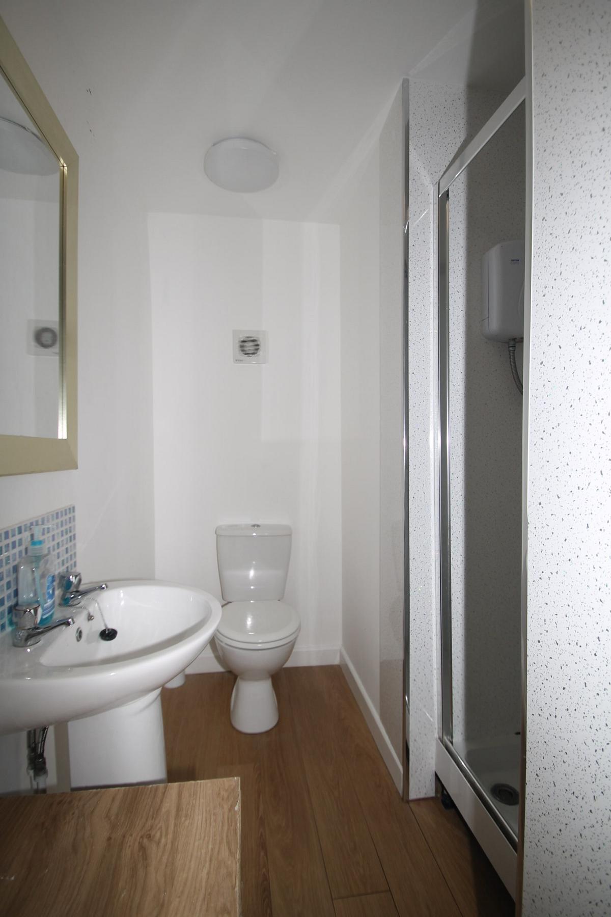 Shared bathroom with shower, toilet and sink