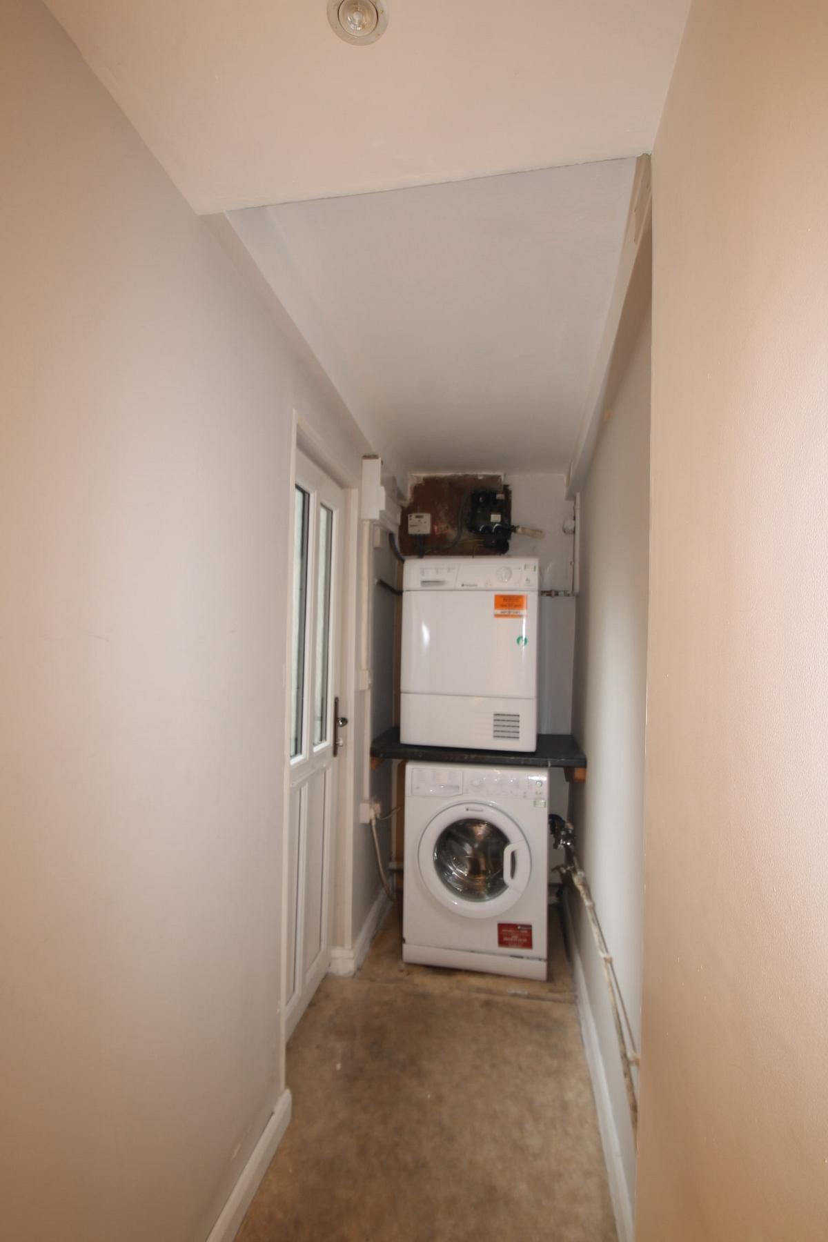 Utility room with washing machine and tumble dryer