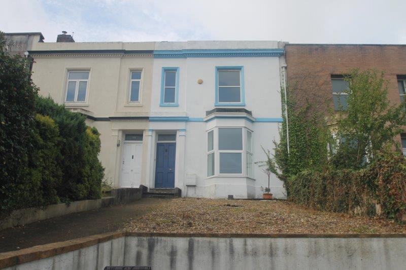 Front of the property, white building with blue details and blue front door