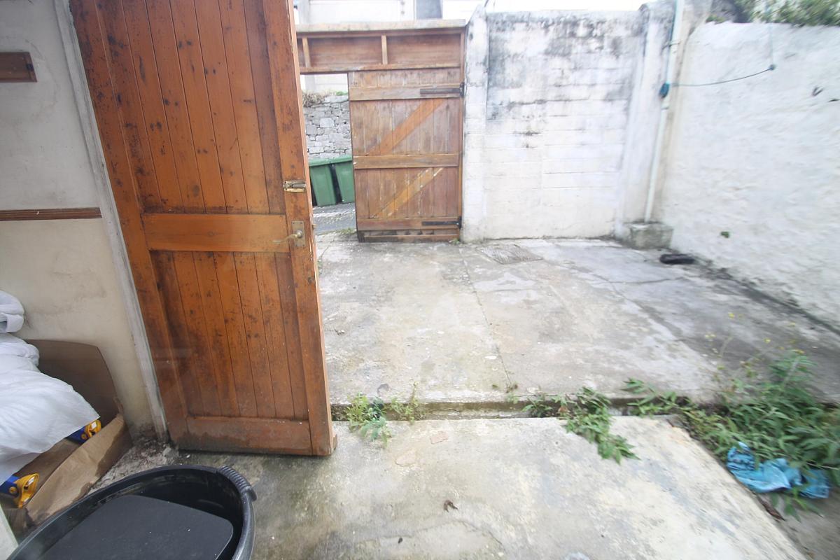Shared back garden leading to back gate