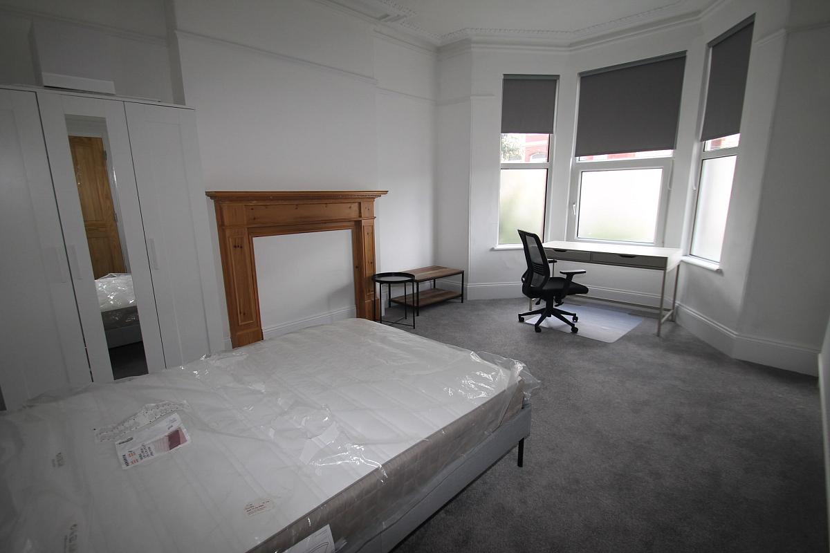 Fourth student bedroom with double bed, two door cupboard and desk