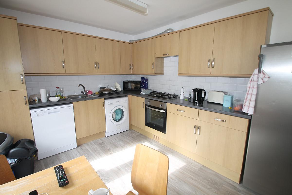 shared kitchen with fridge freezer, gas cooker and hobs, washer/dryer and dishwasher