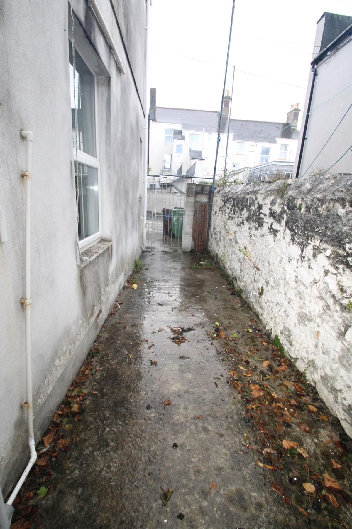 small back garden area leading to back street