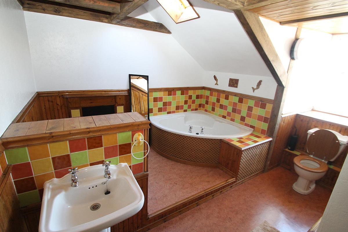 Shared bathroom with large corner bath and shower