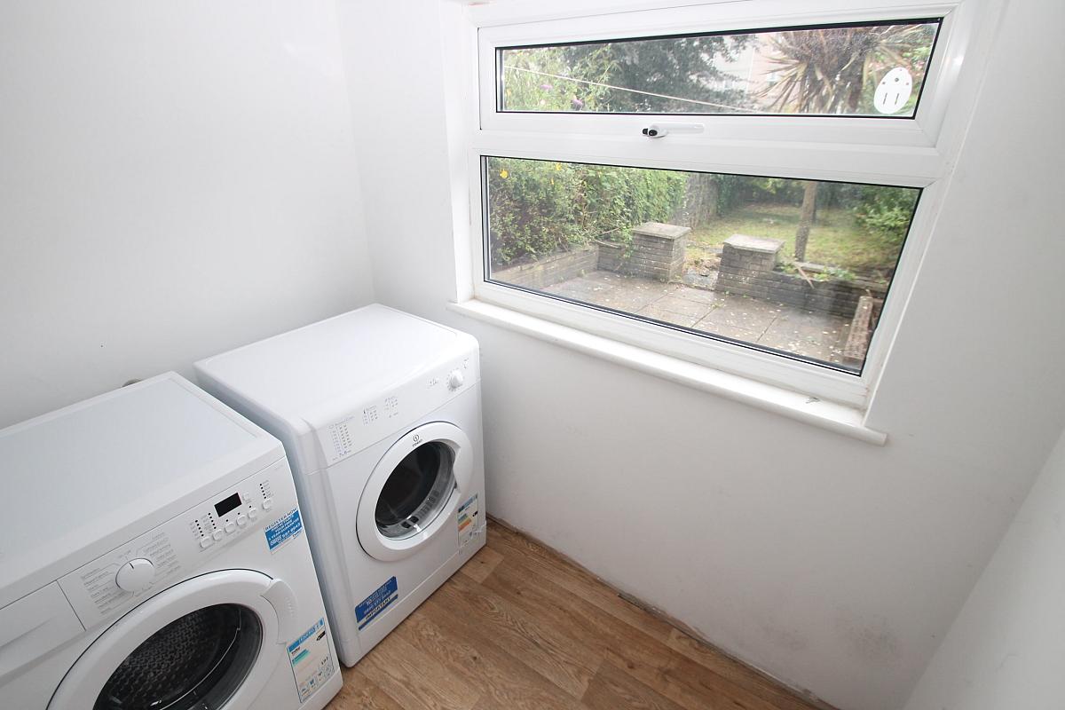 Utility room with washing machine and tumble dryer