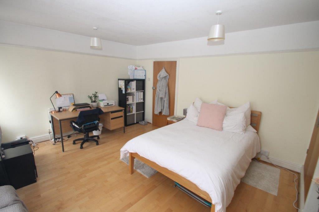 First student room with double bed, two built-in wardrobes and desk