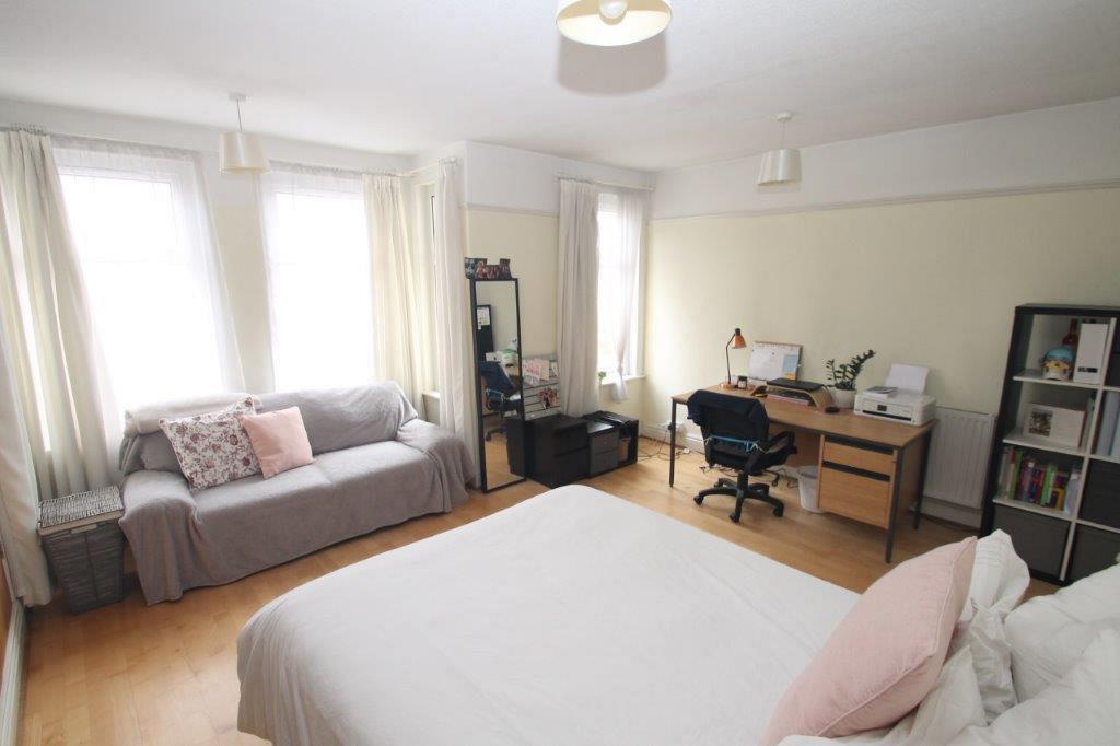 First student room with double bed, desk and two seater sofa