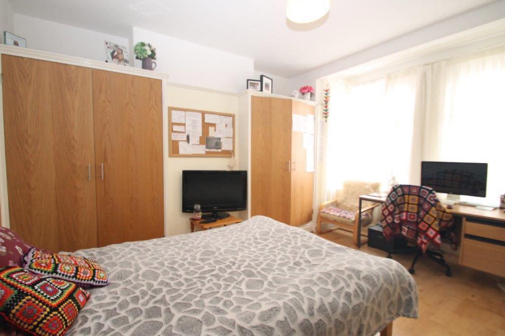 Student bedroom with double bed, two built-in wardrobes and desk