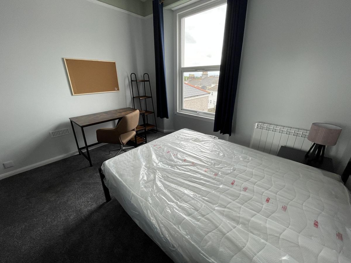 Student bedroom with double bed and desk