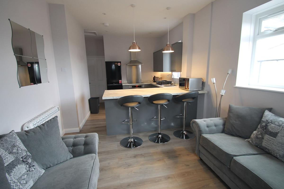 Shared living area and kitchen with breakfast bar