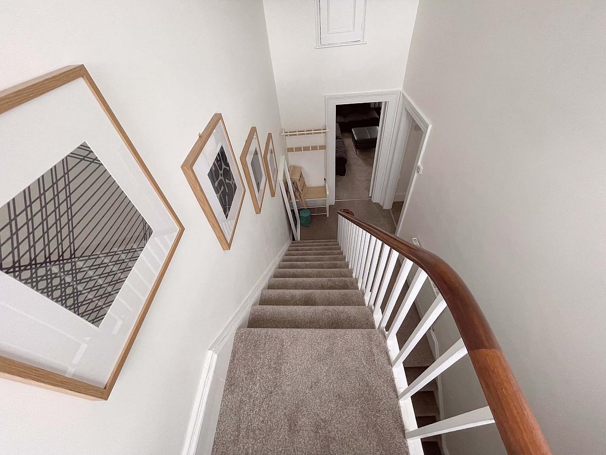 Stairwell from top floor going down and showing entrance into living room