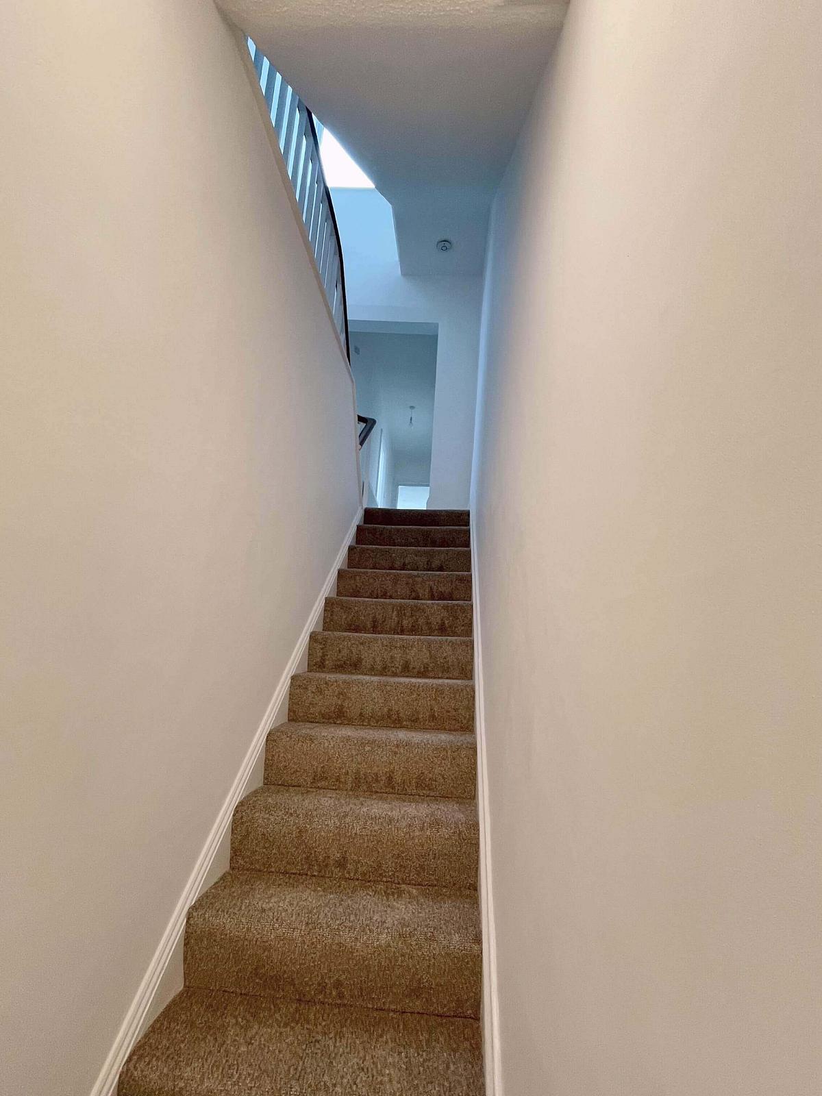 Stairwell from property front door leading up to hallway