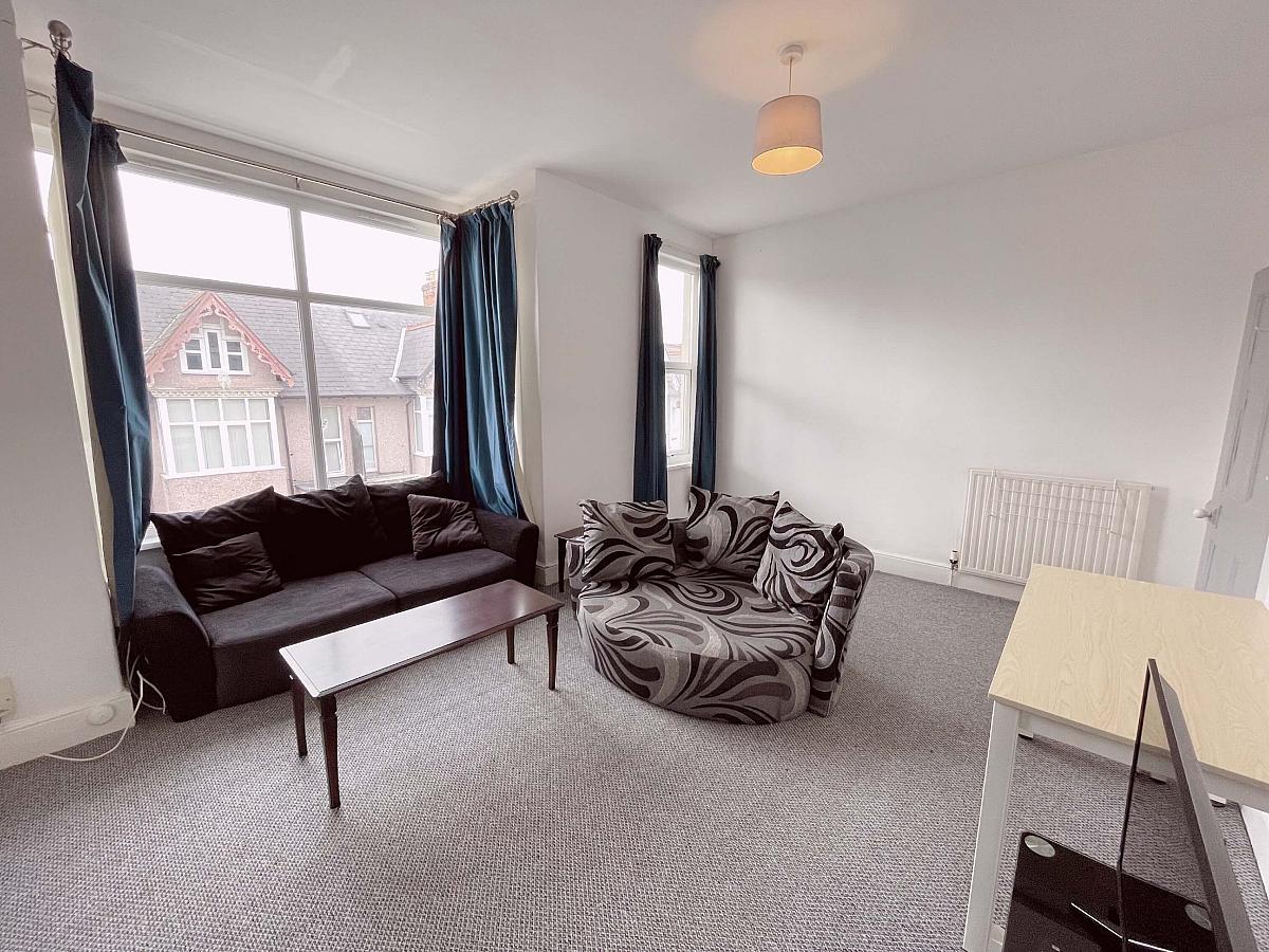 Shared living area with two seater sofa and circle arm chair