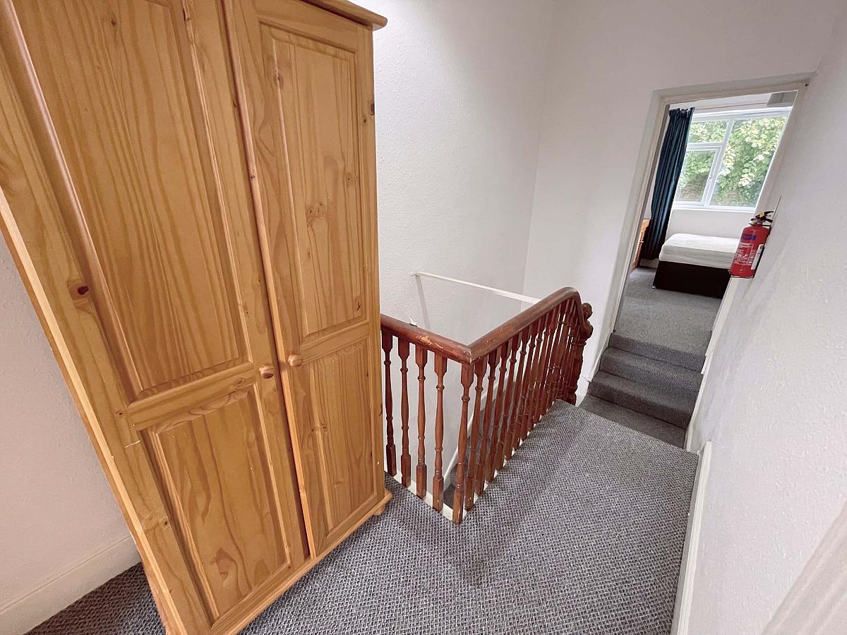 Hallway with two door wardrobe and leading to student room