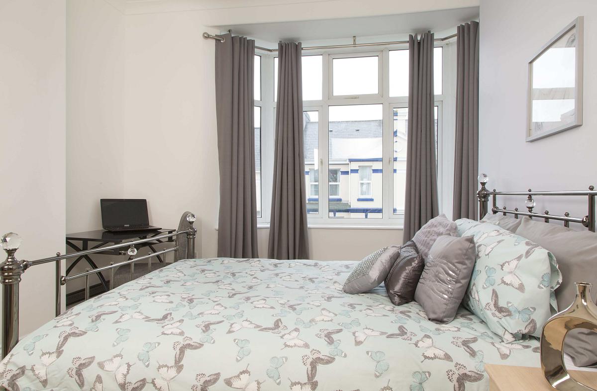 Third student bedroom with double bed, two bedside tables and desk
