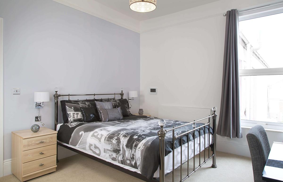 First student bedroom with double bed, bedside tables and desk