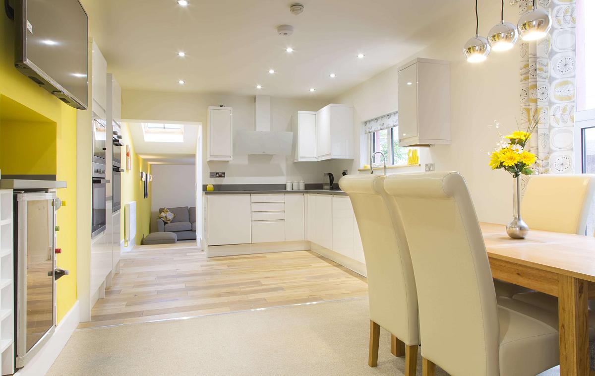 Shared kitchen and dining area leading into living area
