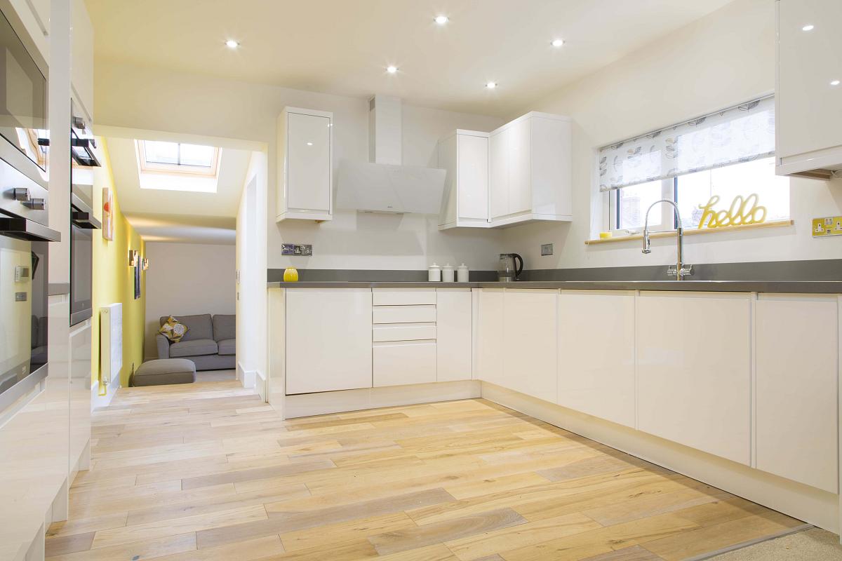 Shared kitchen area with two cookers leading into shared living space