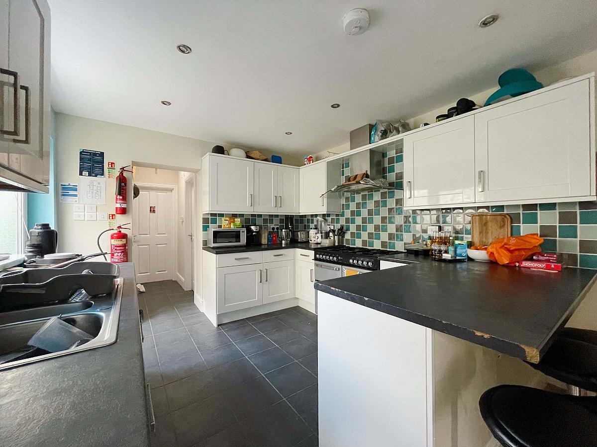 Shared kitchen leading to shared bathroom and living space