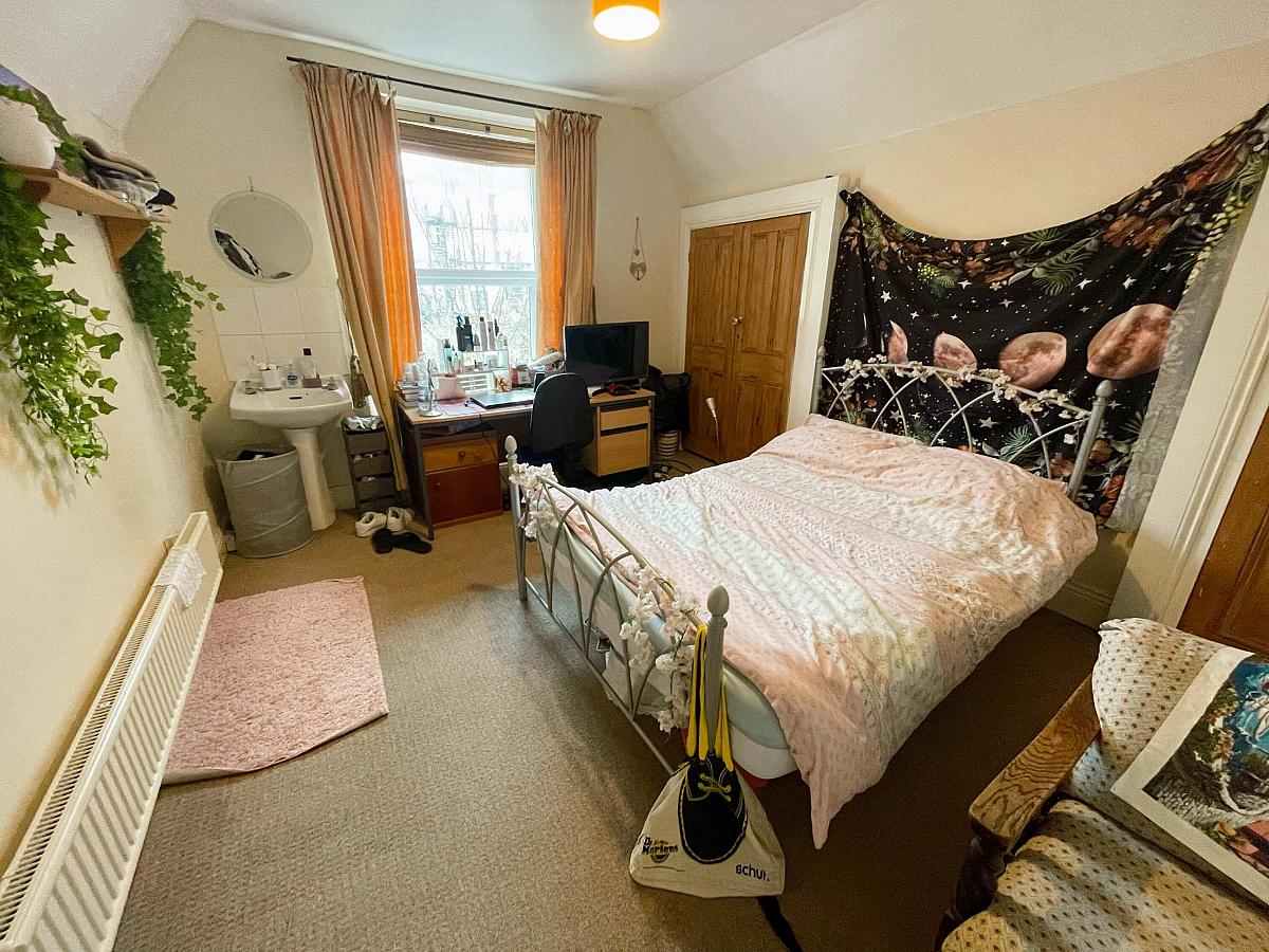Third student bedroom with built-in wardrobe, desk and sink