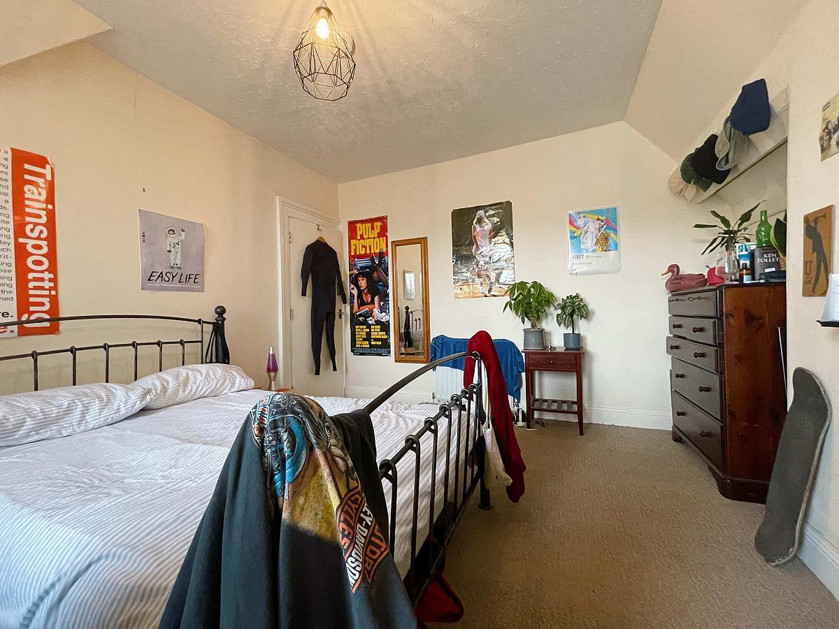 Second student bedroom with double bed, two door built-in wardrobe, chest of drawers and desk